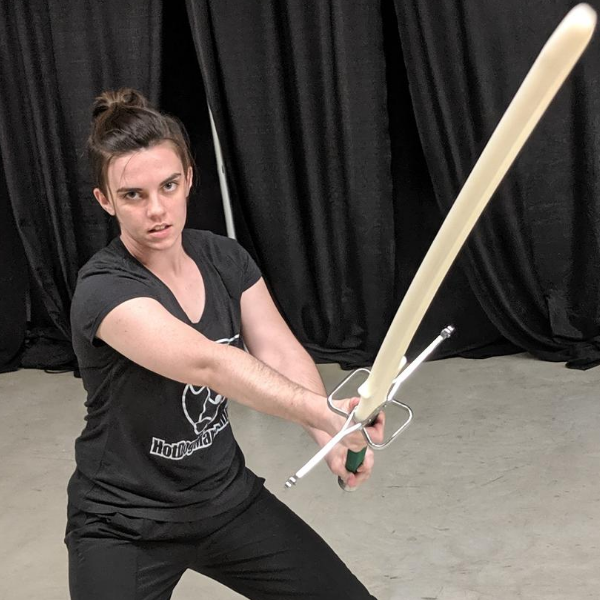 Abigail sword fighting with a montante, or greatsword.