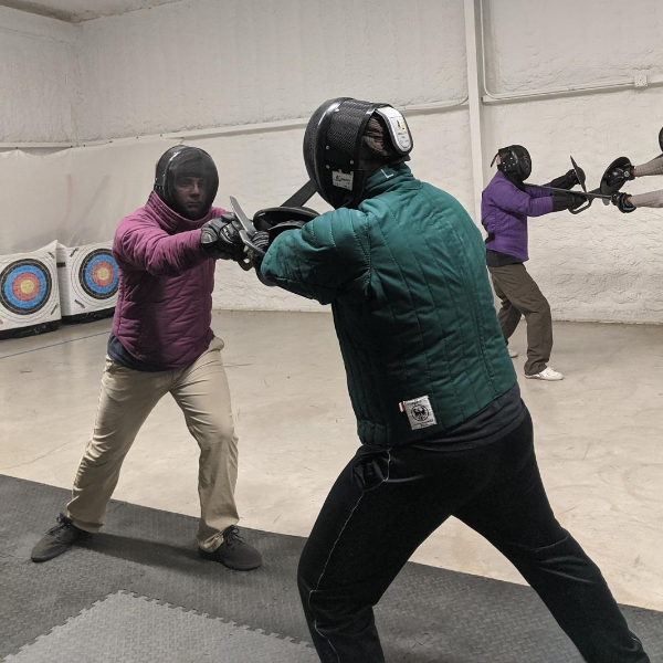 Foundations fight training, a group of students working on sword and buckler drills.